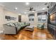 Bright living room featuring hardwood floors, a plush sectional, and a built-in entertainment center at 4400 New Broad St, Orlando, FL 32814