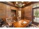 Wood-paneled office featuring a built-in workspace, leather chairs, and sophisticated decor at 4400 New Broad St, Orlando, FL 32814