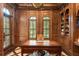 Well-lit office with custom wood finishes, built-in shelving, and two large windows at 4400 New Broad St, Orlando, FL 32814