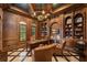 Elegant wood-paneled office with built-in bookshelves, a large desk, and leather seating at 4400 New Broad St, Orlando, FL 32814
