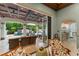 Comfortable outdoor living area with pool views, a coffered ceiling, and easy access to the interior at 4400 New Broad St, Orlando, FL 32814
