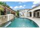 Stunning pool area with rock waterfall feature and lush landscaping, perfect for relaxation and entertaining at 4400 New Broad St, Orlando, FL 32814