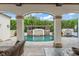 Stunning pool area with water features viewed from the covered outdoor living area at 4400 New Broad St, Orlando, FL 32814