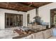 View of the outdoor kitchen with stainless steel appliances, dining area and comfortable seating at 4400 New Broad St, Orlando, FL 32814