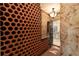 Elaborate wine cellar featuring unique terracotta storage and elegant lighting at 4400 New Broad St, Orlando, FL 32814