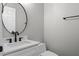 Modern half bathroom featuring a sleek vanity, contemporary fixtures, and fresh design at 461 Black Knight Way, Longwood, FL 32779
