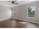 Well-lit bedroom features neutral paint, windows with blinds, and dark laminate wood flooring at 461 Black Knight Way, Longwood, FL 32779