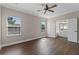 Bedroom featuring two windows, hard wood floors and an open door to a bathroom at 461 Black Knight Way, Longwood, FL 32779