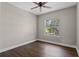 Bright bedroom features a ceiling fan, wood floors, neutral walls, and a window with natural light at 461 Black Knight Way, Longwood, FL 32779