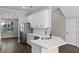 Modern kitchen with stainless steel appliances, a breakfast bar, and a view into dining area at 461 Black Knight Way, Longwood, FL 32779