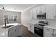 Modern kitchen featuring stainless steel appliances and a sleek, white aesthetic at 461 Black Knight Way, Longwood, FL 32779