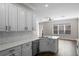 Modern kitchen with white cabinetry, stainless steel appliances, and open layout at 461 Black Knight Way, Longwood, FL 32779