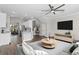Bright living room featuring an open floor plan, ceiling fan, and modern decor at 461 Black Knight Way, Longwood, FL 32779