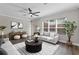 Inviting living room with a large window, comfortable seating, and modern decor at 461 Black Knight Way, Longwood, FL 32779