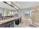Primary bathroom with double sinks, vanity, soaking tub, and glass-enclosed shower at 4993 Hook Hollow Cir, Orlando, FL 32837