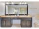 Spacious primary bath with double sinks, vanity, and decorative mirror at 4993 Hook Hollow Cir, Orlando, FL 32837