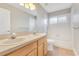 Bright bathroom features a double sink vanity, tile flooring, and a shower over tub at 4993 Hook Hollow Cir, Orlando, FL 32837
