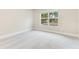 Neutral guest bedroom with neutral walls, neutral carpet, and a large window at 4993 Hook Hollow Cir, Orlando, FL 32837