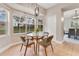 Bright breakfast nook with bay window, glass table, and seating for four near kitchen at 4993 Hook Hollow Cir, Orlando, FL 32837