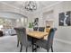 Charming dining room with stylish chairs, a modern chandelier, and views into the living area at 4993 Hook Hollow Cir, Orlando, FL 32837