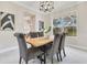Bright dining room featuring a modern table and chairs, with large windows and stylish decor at 4993 Hook Hollow Cir, Orlando, FL 32837