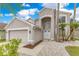 Charming home featuring a manicured lawn, white stone landscaping, and double door entry at 4993 Hook Hollow Cir, Orlando, FL 32837