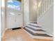 Bright foyer with tile flooring, a staircase, and a high ceiling with large windows at 4993 Hook Hollow Cir, Orlando, FL 32837