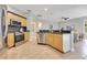 Well-lit kitchen featuring stainless steel appliances, wooden cabinets, and granite countertops at 4993 Hook Hollow Cir, Orlando, FL 32837