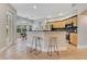 Open kitchen with granite countertop bar and view to the dining area at 4993 Hook Hollow Cir, Orlando, FL 32837
