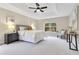 Spacious primary bedroom boasts a tray ceiling, fan, and ample natural light at 4993 Hook Hollow Cir, Orlando, FL 32837