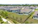 Aerial view of the home featuring a fenced backyard, patio, solar panels, and beautiful landscaping in a residential community at 5220 Red Coral Cir, Mount Dora, FL 32757