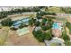 Aerial view of community amenities including tennis courts, a basketball court, and a swimming pool in a landscaped setting at 5220 Red Coral Cir, Mount Dora, FL 32757