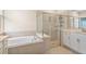Bathroom featuring a bathtub, shower, and double vanity at 5220 Red Coral Cir, Mount Dora, FL 32757