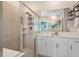 A bathroom with a shower, vanity, and mirror at 5220 Red Coral Cir, Mount Dora, FL 32757