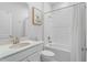 A well-lit bathroom featuring a white vanity, toilet, and a shower-tub combination at 5220 Red Coral Cir, Mount Dora, FL 32757