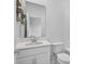 Clean bathroom with white cabinets, sink, mirror, and toilet at 5220 Red Coral Cir, Mount Dora, FL 32757
