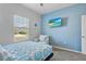 Well-lit bedroom with a mounted TV and chair, creating a comfortable space to relax at 5220 Red Coral Cir, Mount Dora, FL 32757
