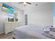Bright bedroom featuring a television, dresser, ceiling fan, and view from the window at 5220 Red Coral Cir, Mount Dora, FL 32757