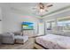 Bedroom with ceiling fan, television, and sitting chair at 5220 Red Coral Cir, Mount Dora, FL 32757