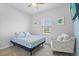 Well-lit bedroom with a chair and window, creating a cozy and inviting space to relax at 5220 Red Coral Cir, Mount Dora, FL 32757