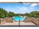 Stunning view of the community pool surrounded by lush landscaping, perfect for relaxation and recreation at 5220 Red Coral Cir, Mount Dora, FL 32757