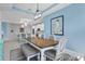 Charming dining area features a wooden table, bench seating, and modern light fixture, perfect for Gathering meals at 5220 Red Coral Cir, Mount Dora, FL 32757
