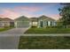 A quaint one-story home showcases a well-manicured lawn and an attached two-car garage at 5220 Red Coral Cir, Mount Dora, FL 32757