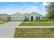 Attractive one-story home with well-maintained lawn, a two-car garage, and inviting curb appeal at 5220 Red Coral Cir, Mount Dora, FL 32757