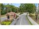 View of the community guard house, ensuring privacy and security, surrounded by lush greenery and manicured landscaping at 5220 Red Coral Cir, Mount Dora, FL 32757