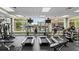 Well-equipped gym with treadmills, exercise bikes, and weight machines, offering views of the pool at 5220 Red Coral Cir, Mount Dora, FL 32757