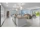 Open-concept kitchen featuring a large island, pendant lighting, and seamless flow to the living area at 5220 Red Coral Cir, Mount Dora, FL 32757