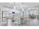 Modern kitchen with a spacious island, white cabinetry, and stainless steel appliances at 5220 Red Coral Cir, Mount Dora, FL 32757