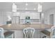 A modern kitchen is equipped with white cabinets, gray countertops, and a spacious island at 5220 Red Coral Cir, Mount Dora, FL 32757