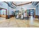Elegant lobby area with tiled floors, decorative chandelier, and comfortable seating for residents and guests at 5220 Red Coral Cir, Mount Dora, FL 32757